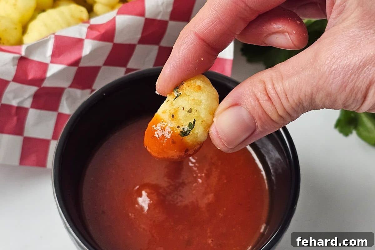 Seasoned Crispy Gnocchi Recipe Serving Crispy air-fried gnocchi being dipped into marinara sauce.