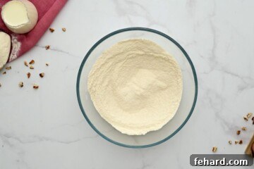 Dry ingredients for Texas Sheet Cake, including flour, sugar, baking soda, and salt, in a mixing bowl.