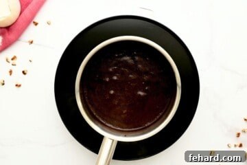 Butter, cocoa powder, and milk combined in a small saucepan, creating the base for the rich cocoa frosting.