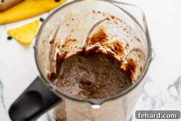 Delicious Instant Pot Black Bean Soup 5 Pureed Black Beans in blender after being pressure cooked.