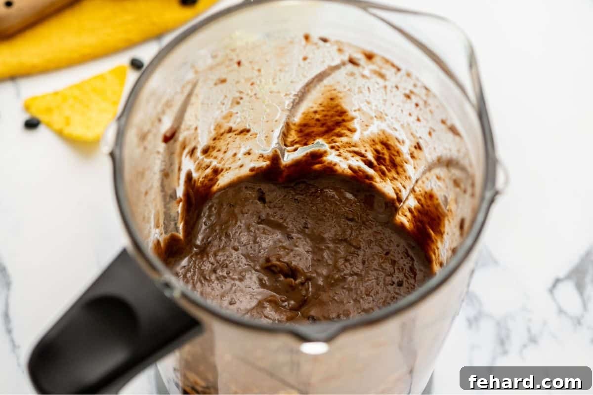 Recipe Pressure Cooker Black Bean Soup Pureed Black Beans in blender after being pressure cooked.