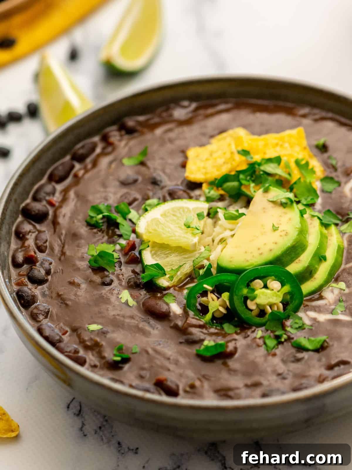 Vegetarian Black Bean Soup Bowl of Instant Pot Black Bean soup topped with cilantro, avocado, and sliced jalapeno.