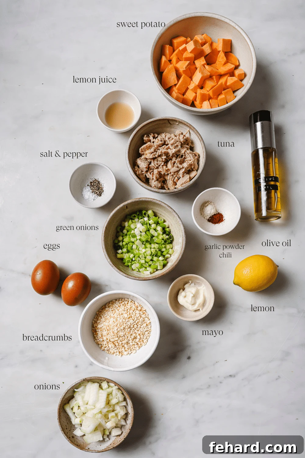 Small bowls containing pre-measured ingredients for tuna patties recipe.