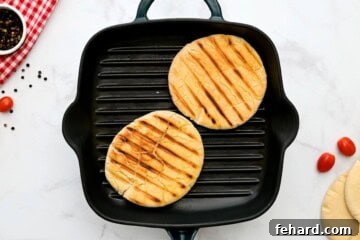 Pitas being toasted on grill plate.