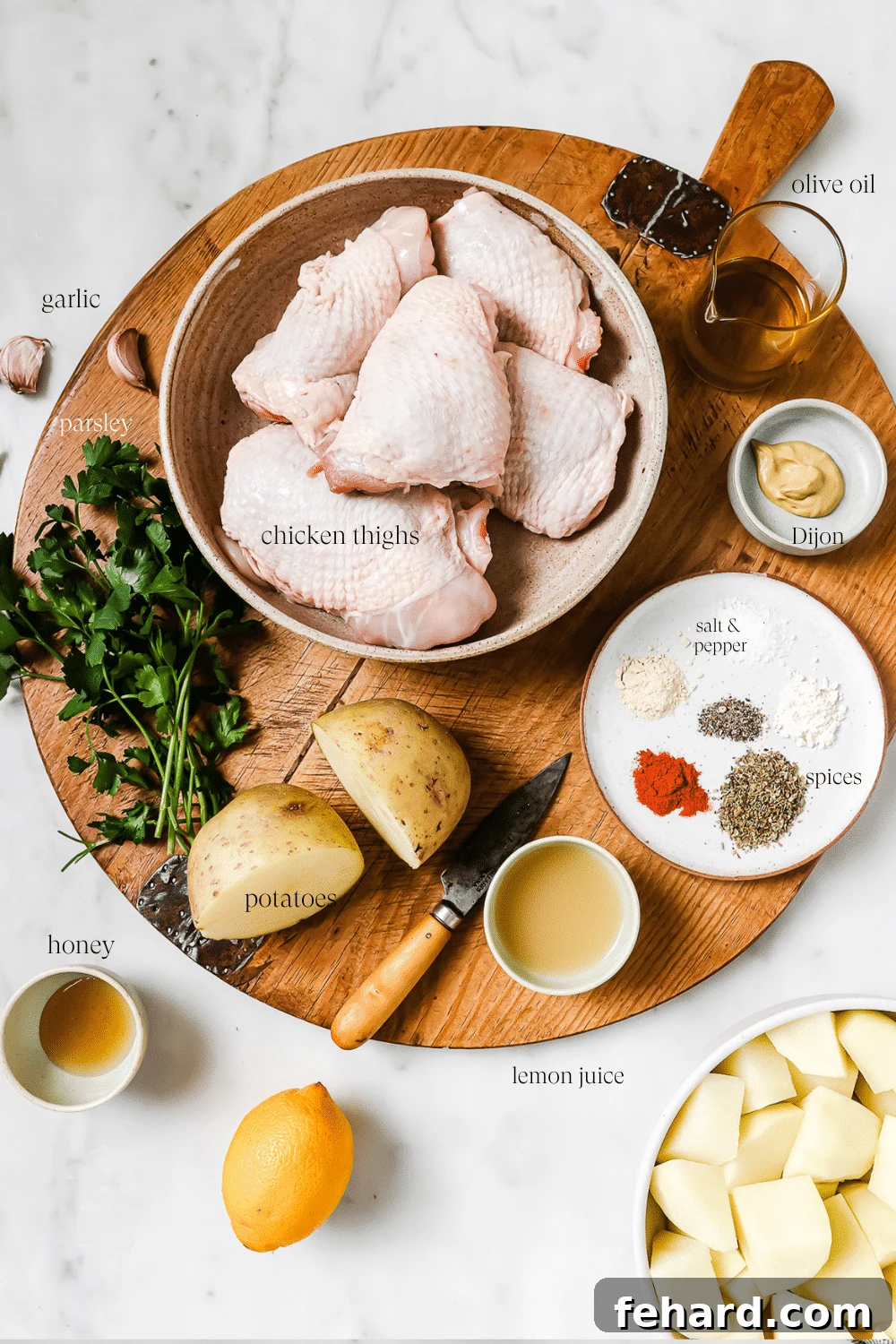 Pre-measured ingredients for Greek chicken and potatoes with text overlay that labels each ingredient.