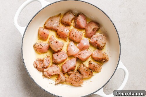 Raw chicken in a skillet