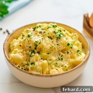Hellmann's Potato Salad dished in large bowl topped with crushed pepper and parsley.