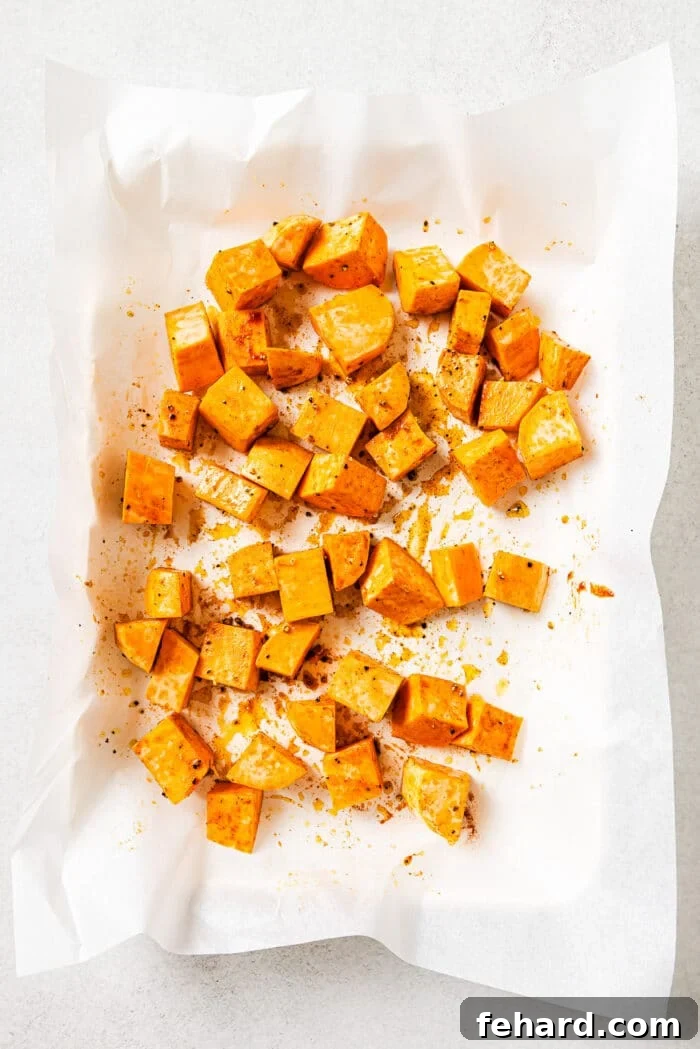 raw diced sweet potato on a baking sheet.