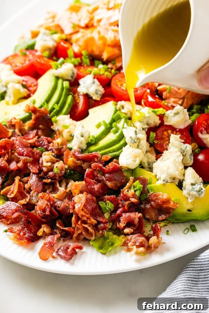 Pour homemade dressing over the salmon cobb salad. 