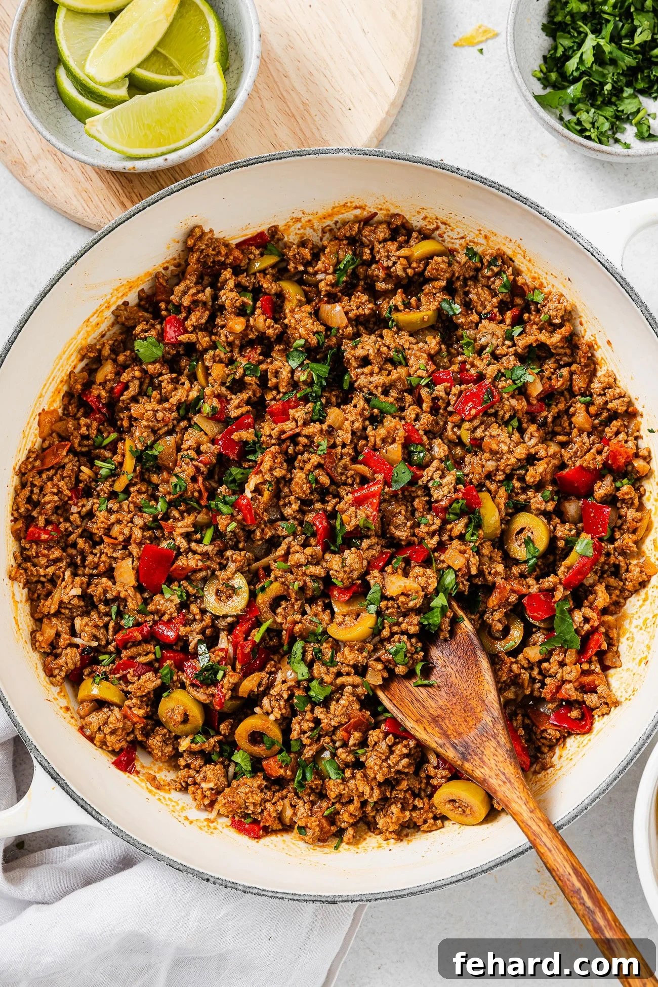 A large skillet filled with freshly prepared Picadillo, generously garnished with vibrant fresh cilantro, ready to be served.