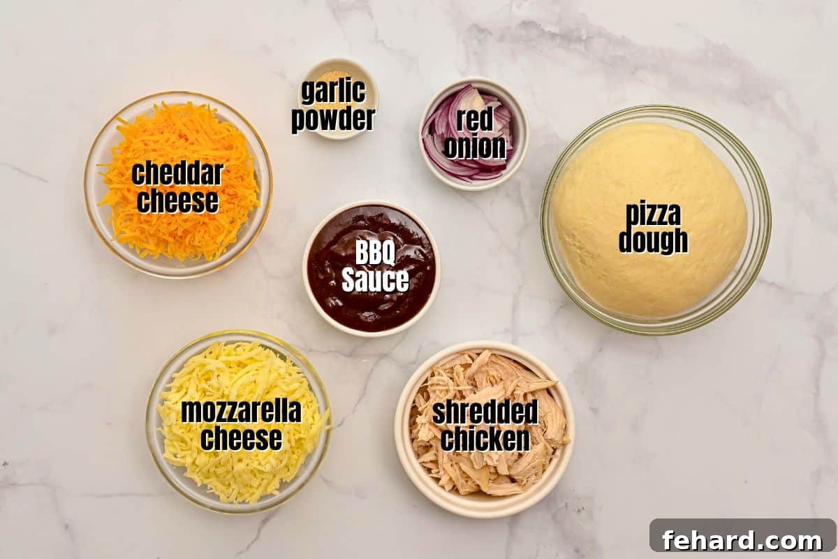 Neatly arranged ingredients for BBQ Chicken Pizza, including pizza dough, BBQ sauce, shredded chicken, cheese, and red onion, on a kitchen counter.