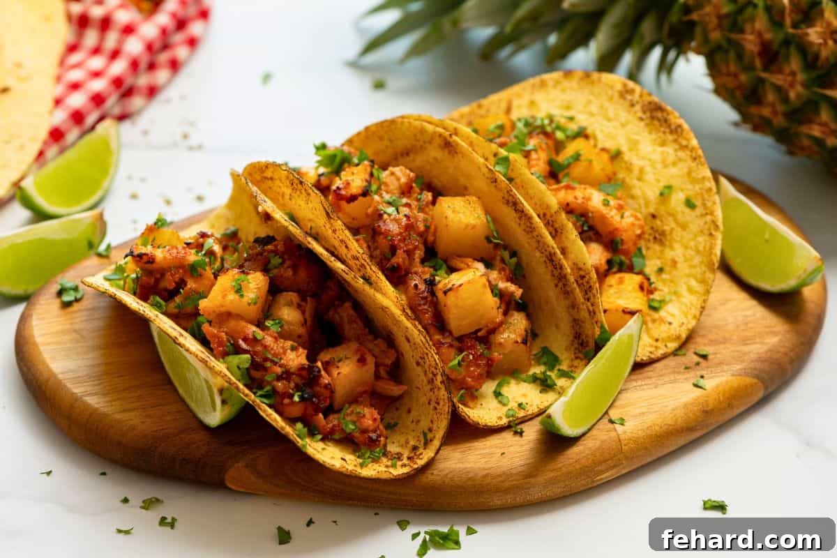 Juicy Chicken Al Pastor served in charred corn tortillas with fresh lime wedges and cilantro garnish, ready to be enjoyed as tacos.