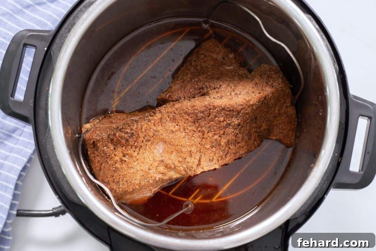 Brisket Recipe Pressure Cooked Brisket inside inner pot on metal trivet.