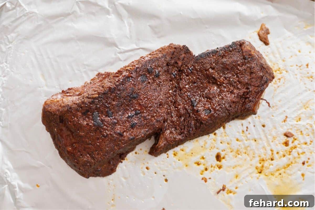 Perfect Brisket Recipe Broiled Instant Pot Brisket on sheet pan lined with foil.