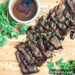 Melt-in-Your-Mouth Instant Pot Brisket 2 Sliced Instant Pot Brisket on wooden cutting board drizzled with BBQ sauce and parsley on the side.