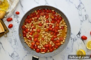 Quick White Bean Pasta with Burst Tomatoes and Fresh Spinach 6 White beans and tomatoes together in saute pan.