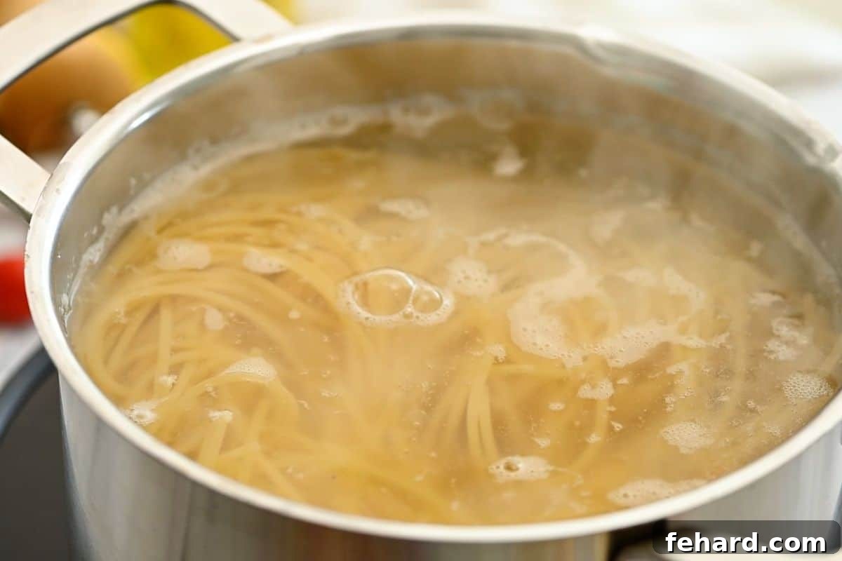 Pasta with White Beans Cooking Noodles cooking in boiling, generously salted water in a large pot.