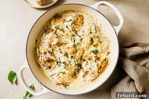 Finished Marry Me Chicken in a creamy sauce, ready to be served from a white skillet.
