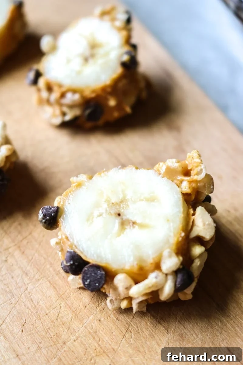Sliced Chocolate Peanut Butter Banana Sushi on a cutting board, ready to serve.