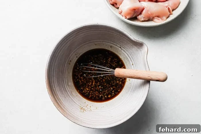 Teriyaki marinade whisked together in a large mixing bowl.