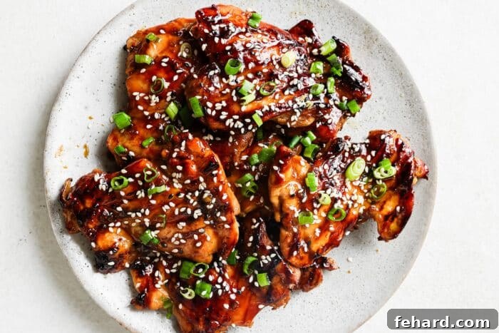 Teriyaki marinated chicken on a white serving plate, ready to be garnished.