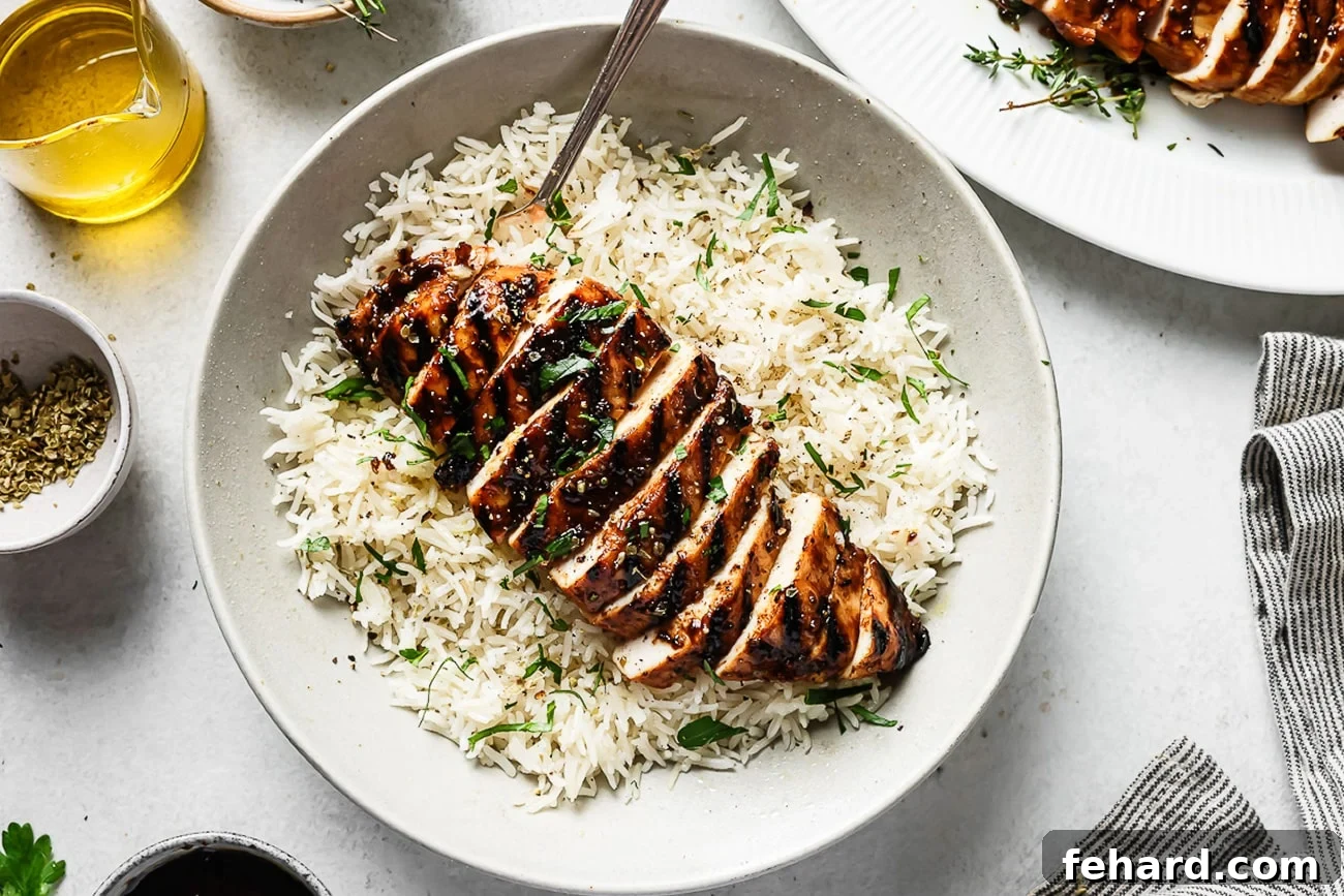 Signature Balsamic Chicken Marinade 10 Balsamic chicken served over fluffy white rice on a clean white plate, garnished for presentation.