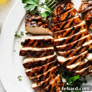 A perfectly cooked balsamic chicken breast, sliced and ready for serving.