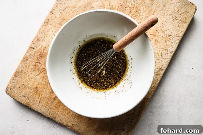 Signature Balsamic Chicken Marinade 4 Balsamic marinade mixture in a white bowl, ready for chicken.