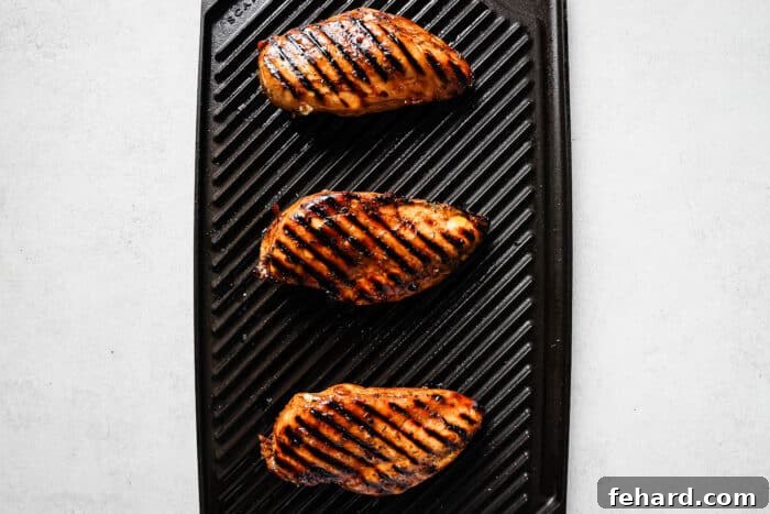 Signature Balsamic Chicken Marinade 6 Balsamic chicken breasts grilling on an outdoor grill.
