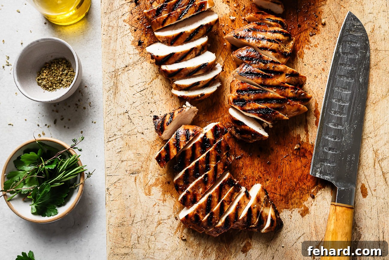 Signature Balsamic Chicken Marinade 8 Succulent grilled balsamic chicken resting on a rustic wooden board, ready to be sliced.