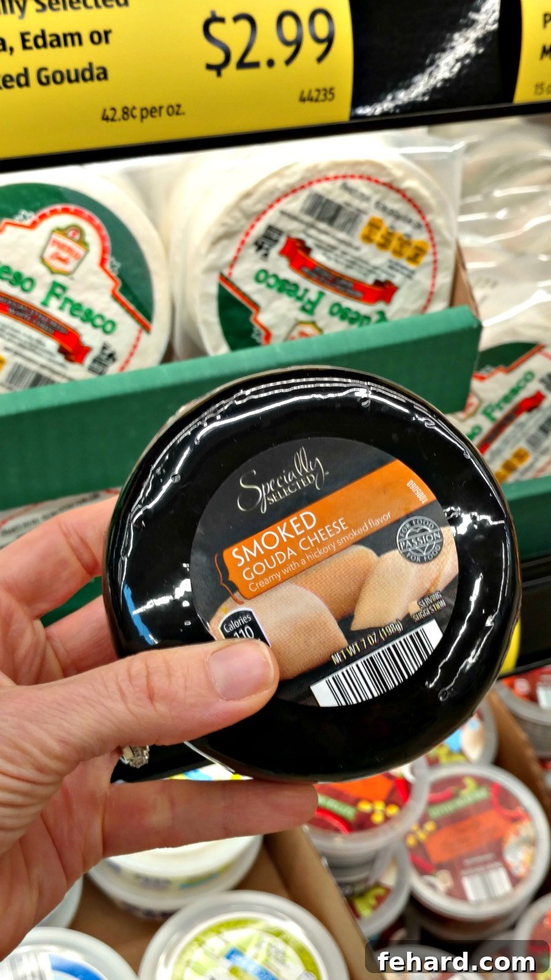 Aldi 10 Best Buys 9 Smoked Gouda cheese next to a selection of specialty cheeses, illustrating ALDI's impressive and affordable cheese offerings.