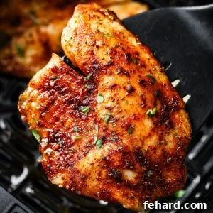 Close-up of a tilapia fillet on a spatula.