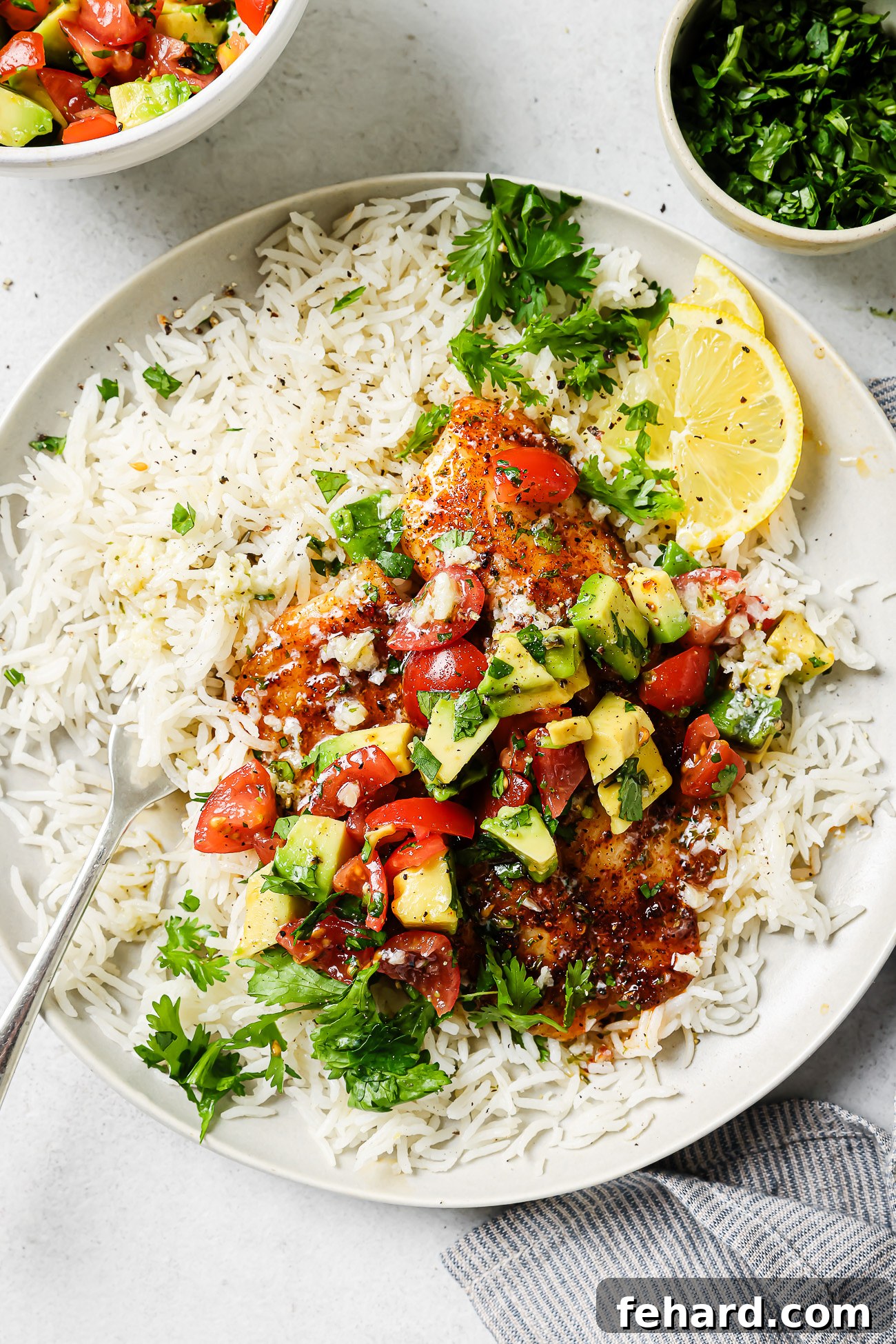 Cooked air fryer tilapia fillet on a plate with rice and pico de gallo. 🌮🍚🐟