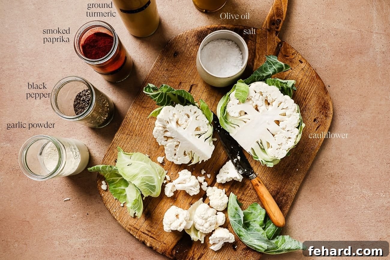 ingredients to make air fryer cauliflower on a wooden board. 