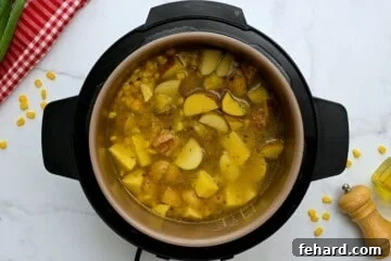 Speedy Instant Pot Potato Corn Chowder 4 Cubed Yukon gold potatoes, corn, and broth insider inner pot before pressure cooking potato corn chowder.