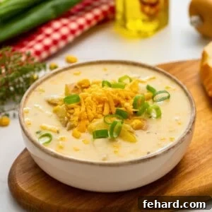 Speedy Instant Pot Potato Corn Chowder 2 Bowl of creamy Instant Pot Potato Corn Chowder topped with shredded cheese and sliced green onions.