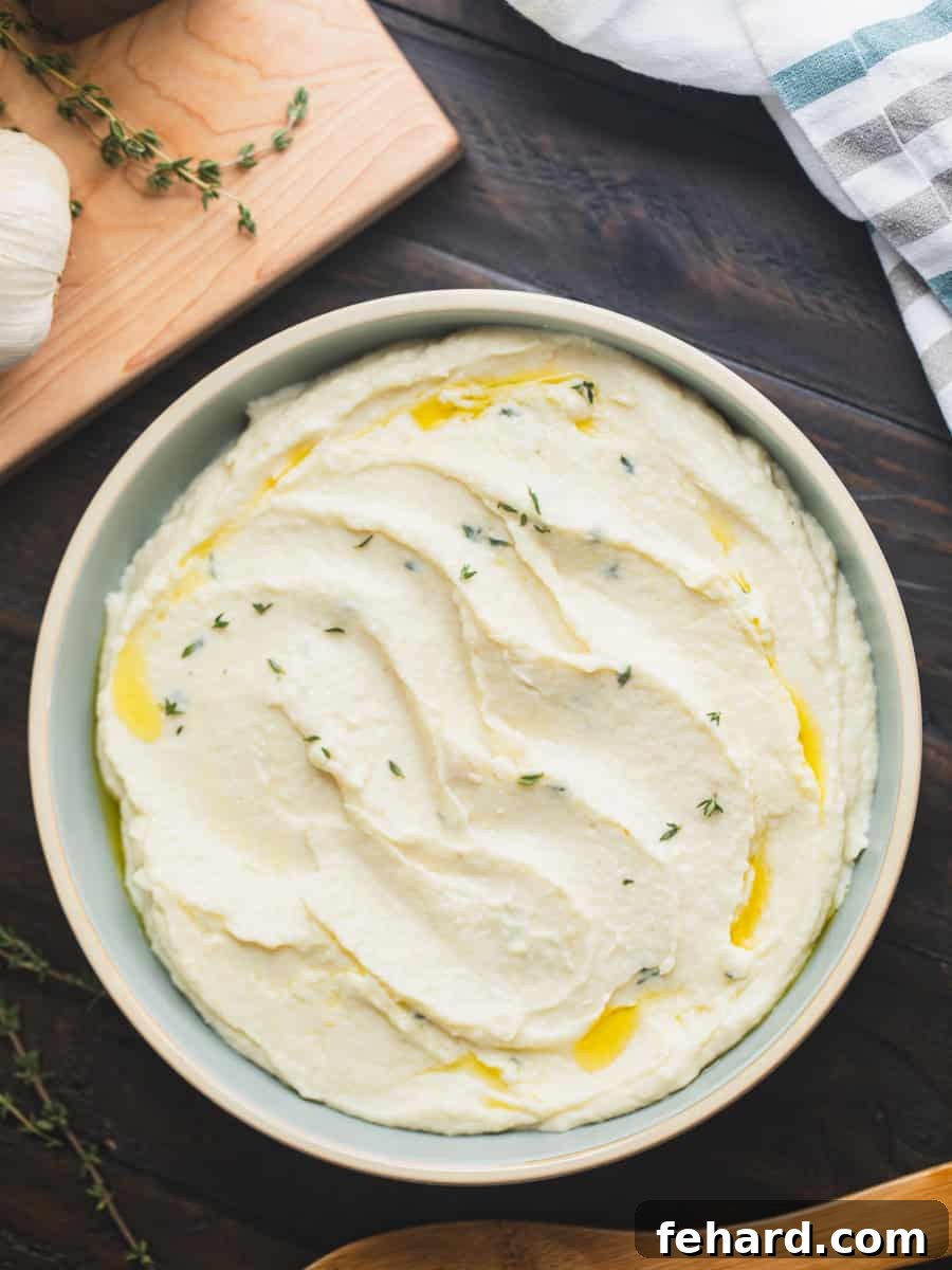 Parsnip Puree with Garlic and Horseradish Bowl of creamy parsnip puree with garlic and horseradish, drizzled with olive oil and garnished with fresh thyme leaves.