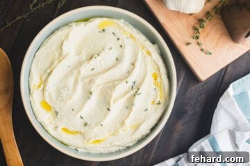 Silky Parsnip Puree 6 Bowl of creamed parsnips made with cream topped with olive oil with fresh thyme.