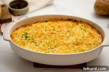 Steakhouse Potatoes Romanoff in casserole topped with minced chives.
