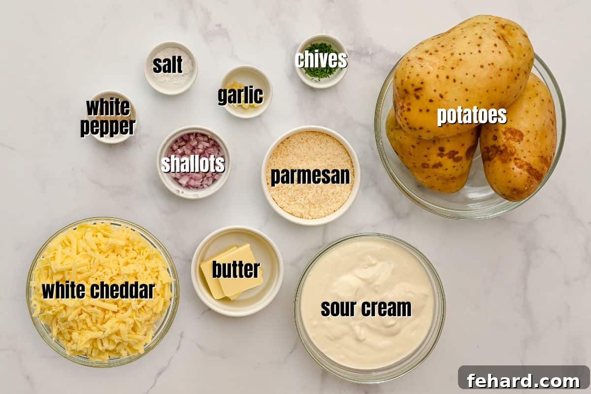 Potatoes Romanoff Ingredients Carefully arranged ingredients for Potatoes Romanoff on a kitchen counter: Russet potatoes, blocks of cheese, sour cream, butter, shallots, garlic, and spices.