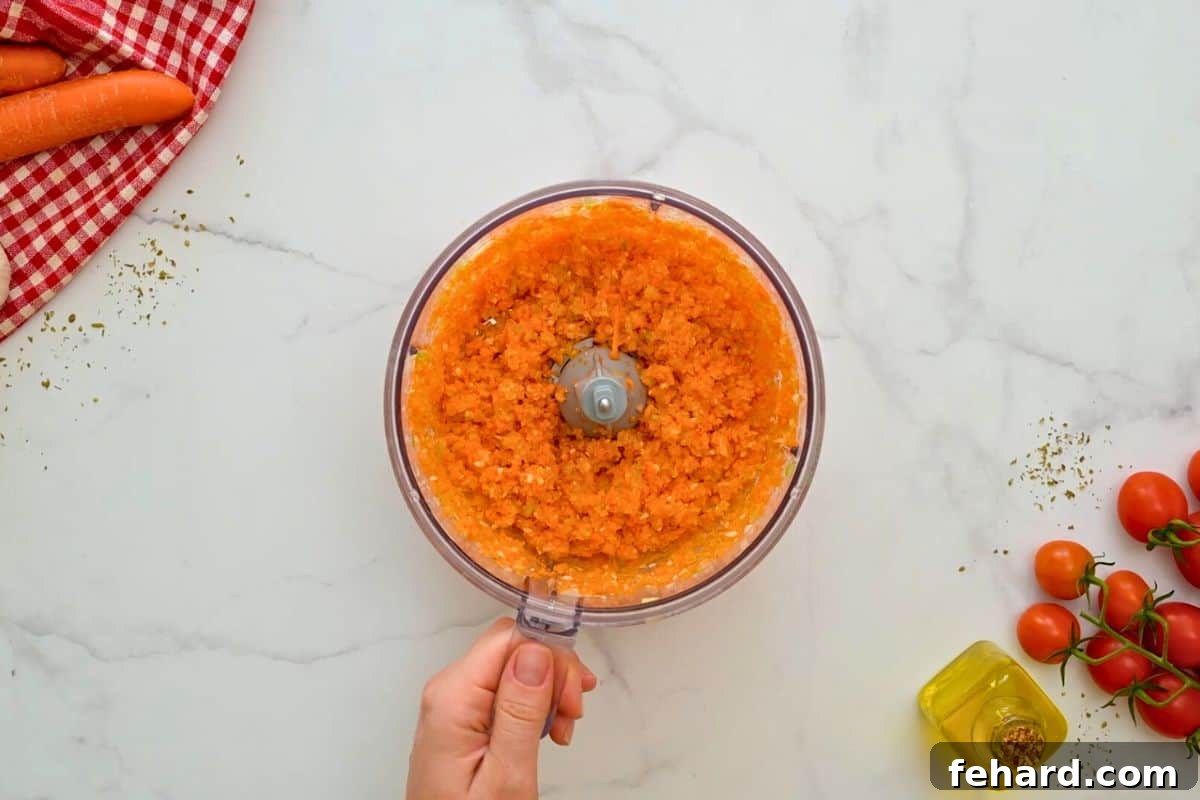 Instant Pot Bolognese Sauce Recipe Mini food processor with ingredients for sofrito pulsed together for Instant Pot Bolognese.