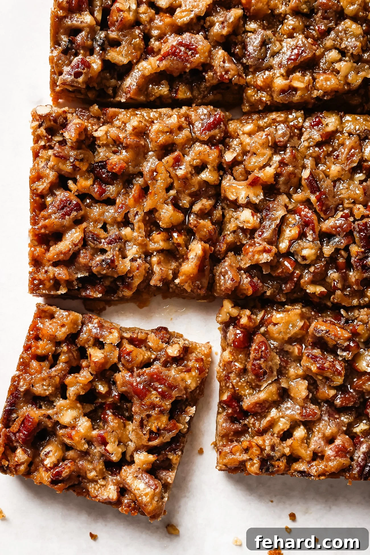 Irresistible Gluten-Free Pecan Bars 2 Close up of gluten-free pecan pie bars on a countertop, showcasing their rich texture and golden crust.