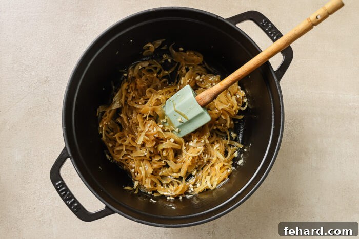 sauteed onions in a black Dutch oven pot.