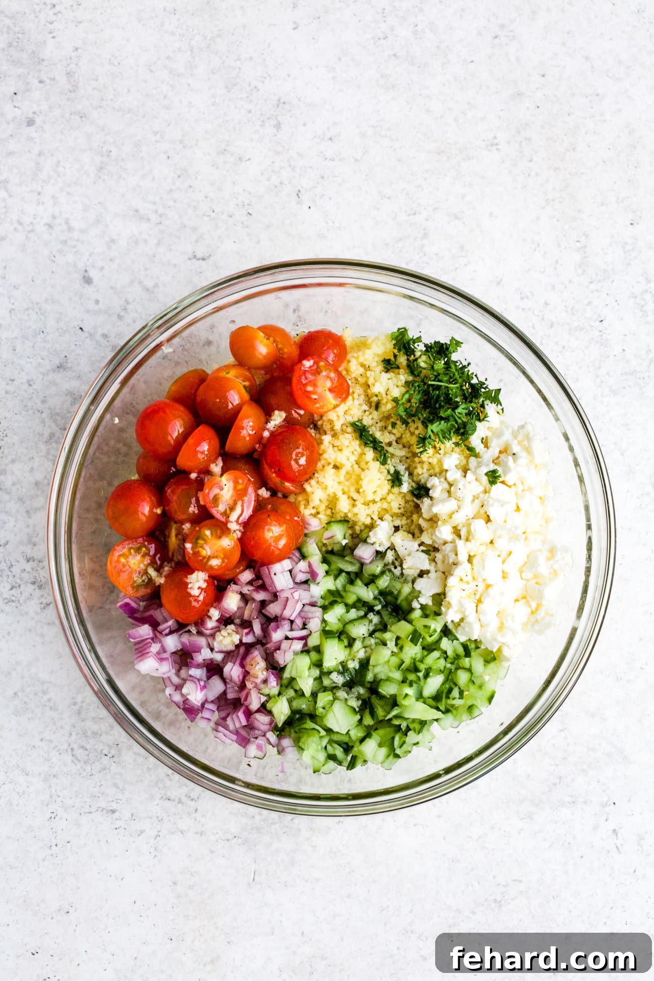 Salad ingredients measured into a large mixing bowl. 