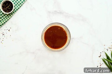 Homemade Hunan Sauce in small bowl next to fresh green beans, ready for use in the stir-fry.