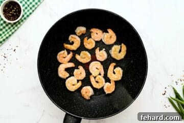 Succulent shrimp, perfectly sauteed in a large pan after being coated in cornstarch.