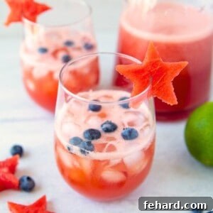 Watermelon Sangria in glass with watermelon stars garnished with blueberries.