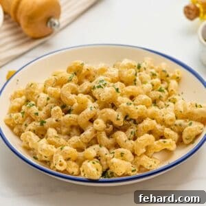 Cavatappi noodles coated in creamy parmesan sauce topped with minced parsley.