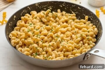 Creamy Cavatappi Perfection 7 Cavatappi noodles in parmesan cream sauce with minced parsley in a skillet, ready to serve.