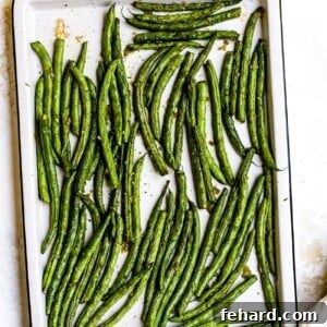 Roasted green beans on a baking sheet.